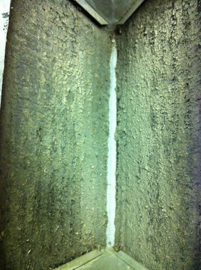 A dirty air conditioner evaporator coil with biofilms [Photo by Energy Vanguard]