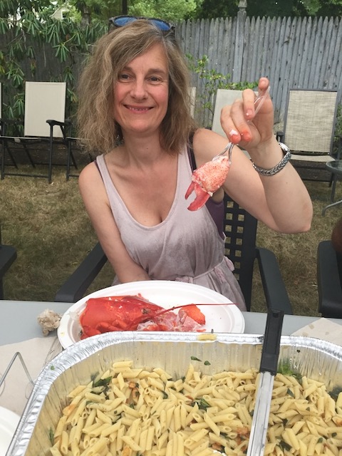 Kat Klingenberg, co-founder of PHIUS, eating lobster in the backyard at Summer Camp