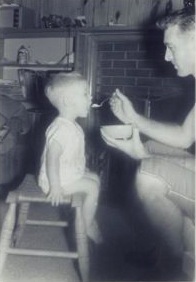 That's me as a toddler, getting fed by my dad
