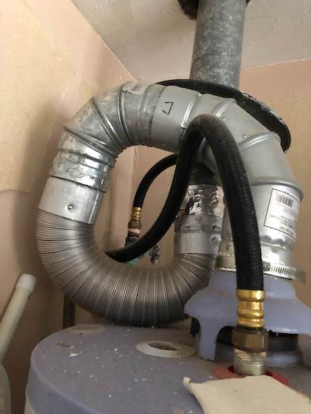 Natural draft water heater flue trap [Photo by Jason Fisher, Bryan, TX]