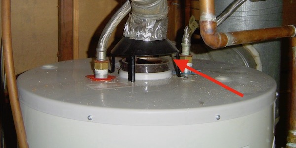 A natural draft water heater has a gap between the tank and the vent [Photo by Energy Vanguard]